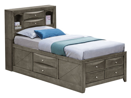 The Marilla Storage Bed With Bookcase Headboard is a gray wooden twin bed with built-in storage drawers under the frame and shelves in the headboard for books and decor. It comes dressed in white, blue, and gray bedding.