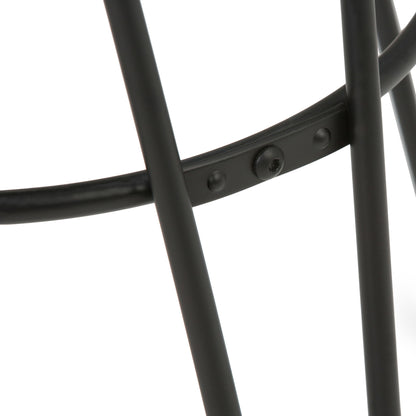 Close-up of intersecting black legs joined by a small bolt on the Simeon Multifunctional Metal Stool With Wood Seat, set against a white background.