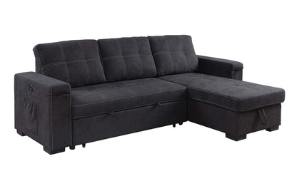 The Toby Woven Fabric Reversible Sleeper Sectional features dark gray upholstery, wide armrests, three back cushions, a right-side storage chaise, white stitching, a left arm pocket, cup holder, and built-in charging ports.