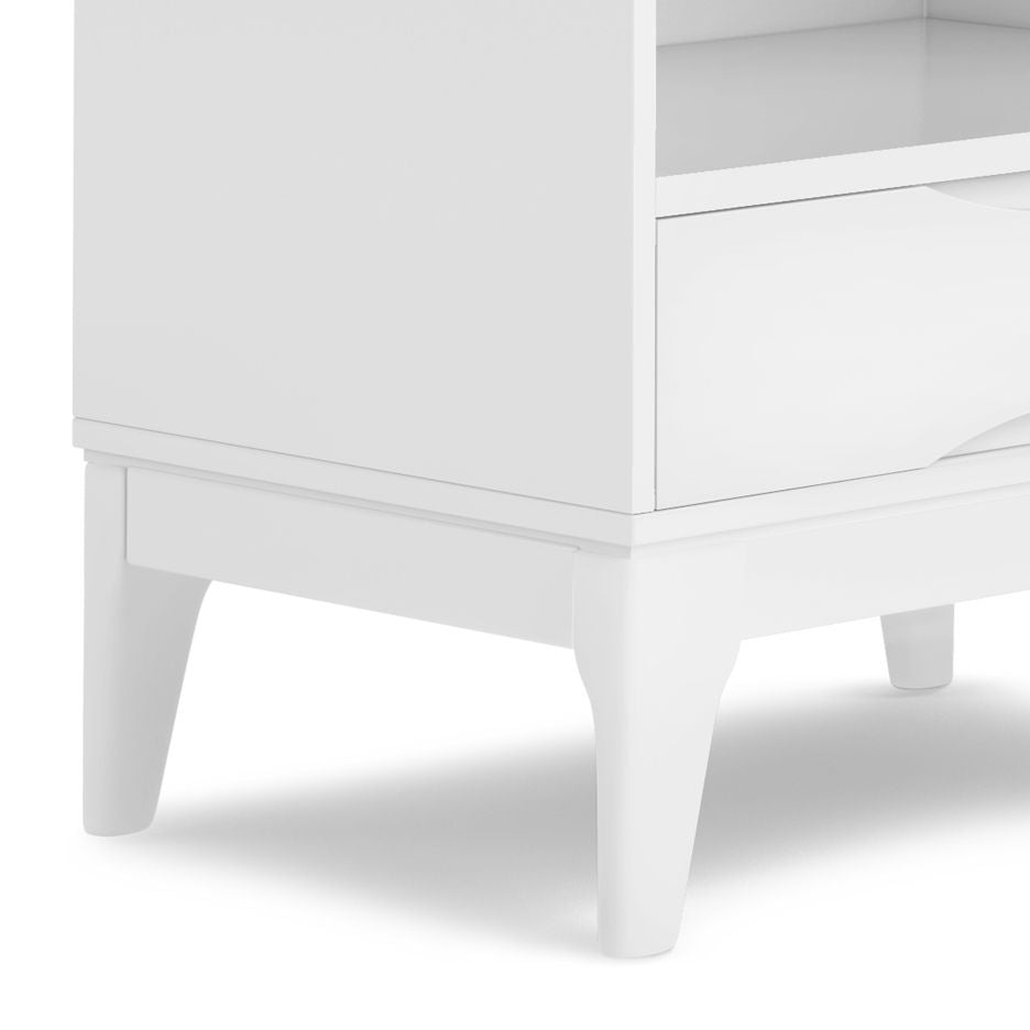 Close-up of the Harper - Handcrafted Bookcase With Storage, highlighting its lower half with tapered legs, a smooth drawer front, and an open shelf positioned above the drawer.
