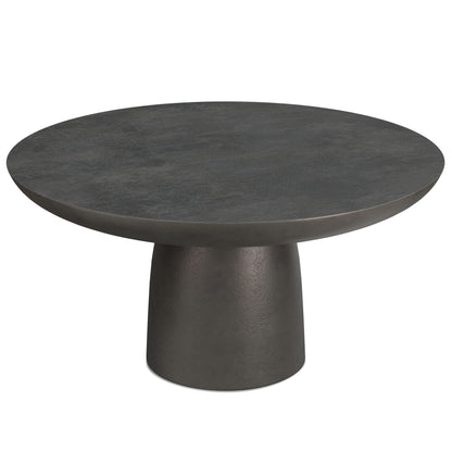 The Alexa Cast Aluminum Coffee Table features a modern round black top with a wide, stone-like surface and a matching cylindrical tapered pedestal base.