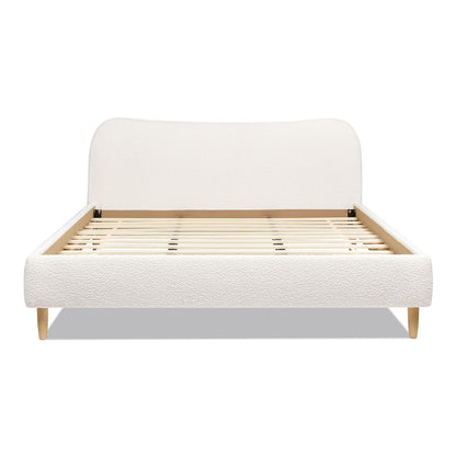 The Roman - Curved Headboard Upholstered Platform Bed features a modern curved white upholstered headboard, light wood slats, and angled wooden legs. Displayed without a mattress.