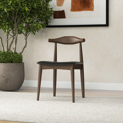 The Destiny - Modern Dining Chairs (Set of 2) feature wooden frames and dark seat cushions, placed on a light carpet by a potted plant. Abstract earthy-toned art hangs behind, complementing the room’s neutral decor.