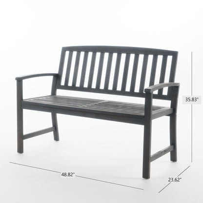 The Farmhouse Style Loja Bench is a dark wooden indoor/outdoor bench featuring a slatted back and seat, curved armrests, and measures 35.83" H x 48.82" W x 23.62" D.