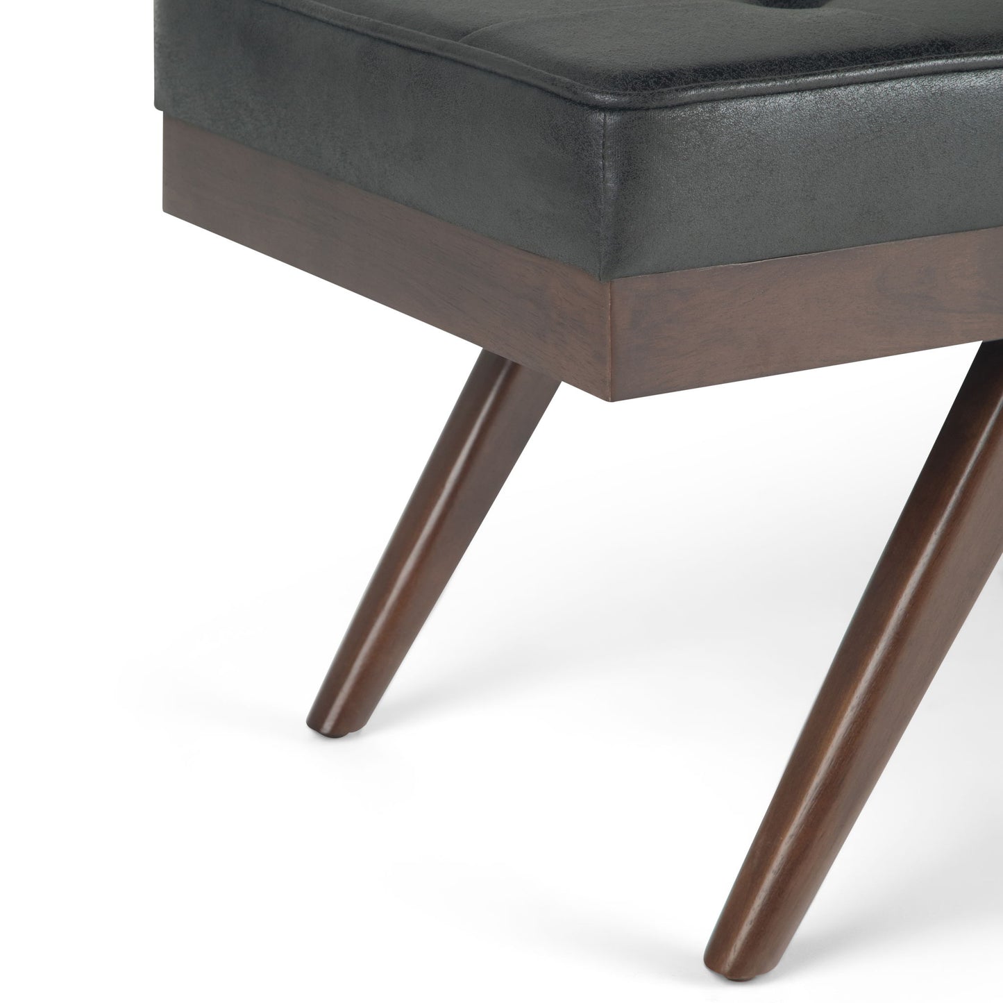 Close-up of the Pierce - Mid Century Upholstered Ottoman Bench featuring angled wooden legs with a rich brown finish and a tightly fitted dark upholstered cushioned seat.
