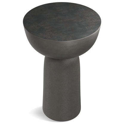 The Hughes Cast Aluminum Side Table in black features a modern, minimalist design with a round, slightly bowl-shaped top and a textured cylindrical base.