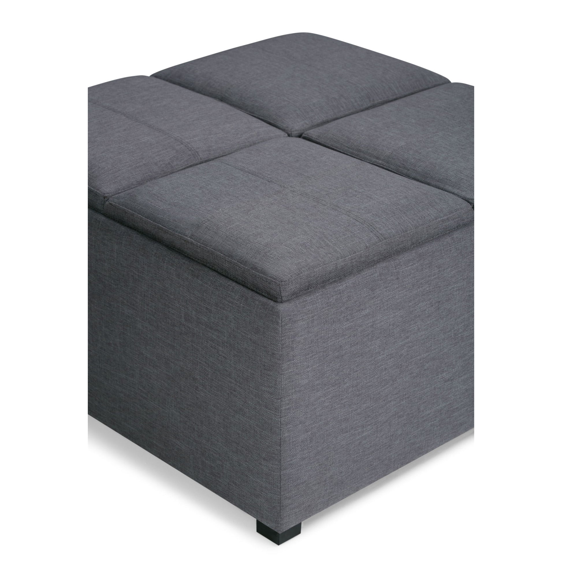 The Avalon Square Coffee Table Storage Ottoman features a modern gray upholstered design with four padded sections on top, displayed on a white background.