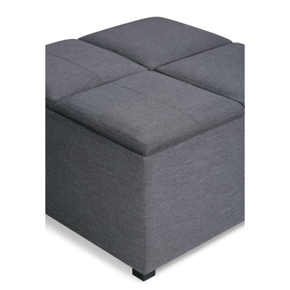 The Avalon Square Coffee Table Storage Ottoman features a modern gray upholstered design with four padded sections on top, displayed on a white background.
