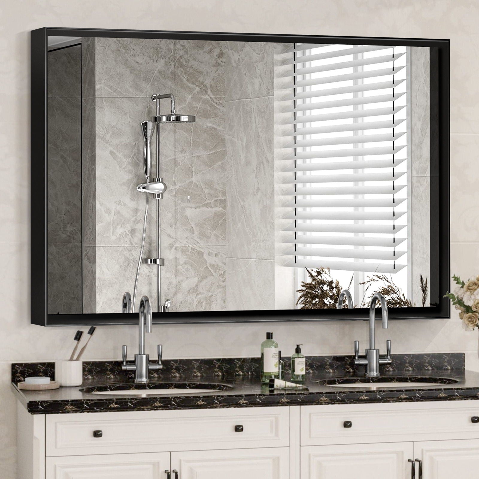 A Rectangular Bathroom Mirror with a square angle metal frame is mounted above a double sink vanity with marble countertop, soap dispenser, and toothbrush holder; it reflects a tiled shower with rainfall showerhead and window blinds.