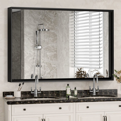 A Rectangular Bathroom Mirror with a square angle metal frame is mounted above a double sink vanity with marble countertop, soap dispenser, and toothbrush holder; it reflects a tiled shower with rainfall showerhead and window blinds.
