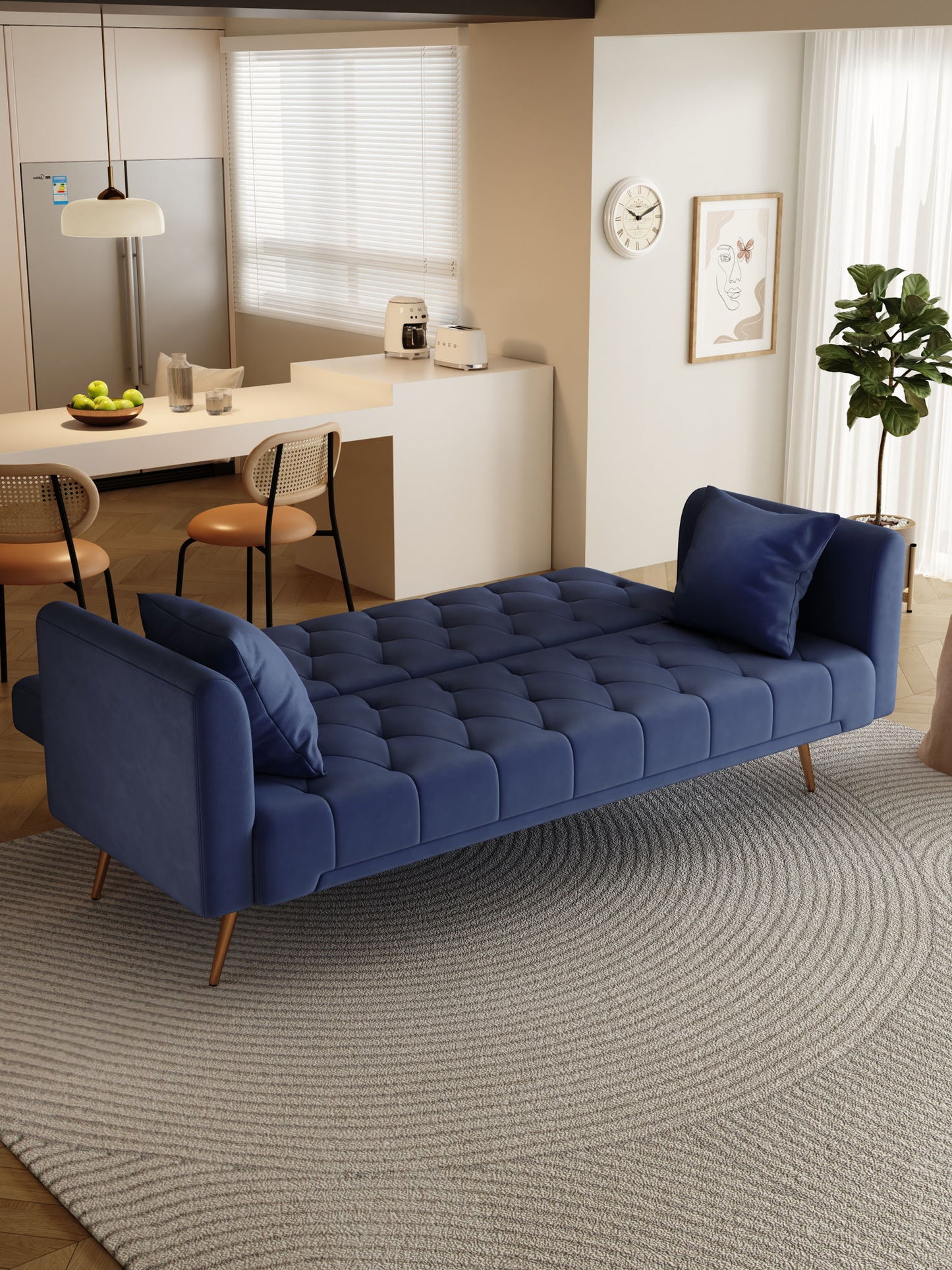 A modern living room features a Convertible Double Folding Living Room Sofa Bed with two matching pillows on a round gray rug, set against a backdrop of a kitchen and dining area filled with natural light.
