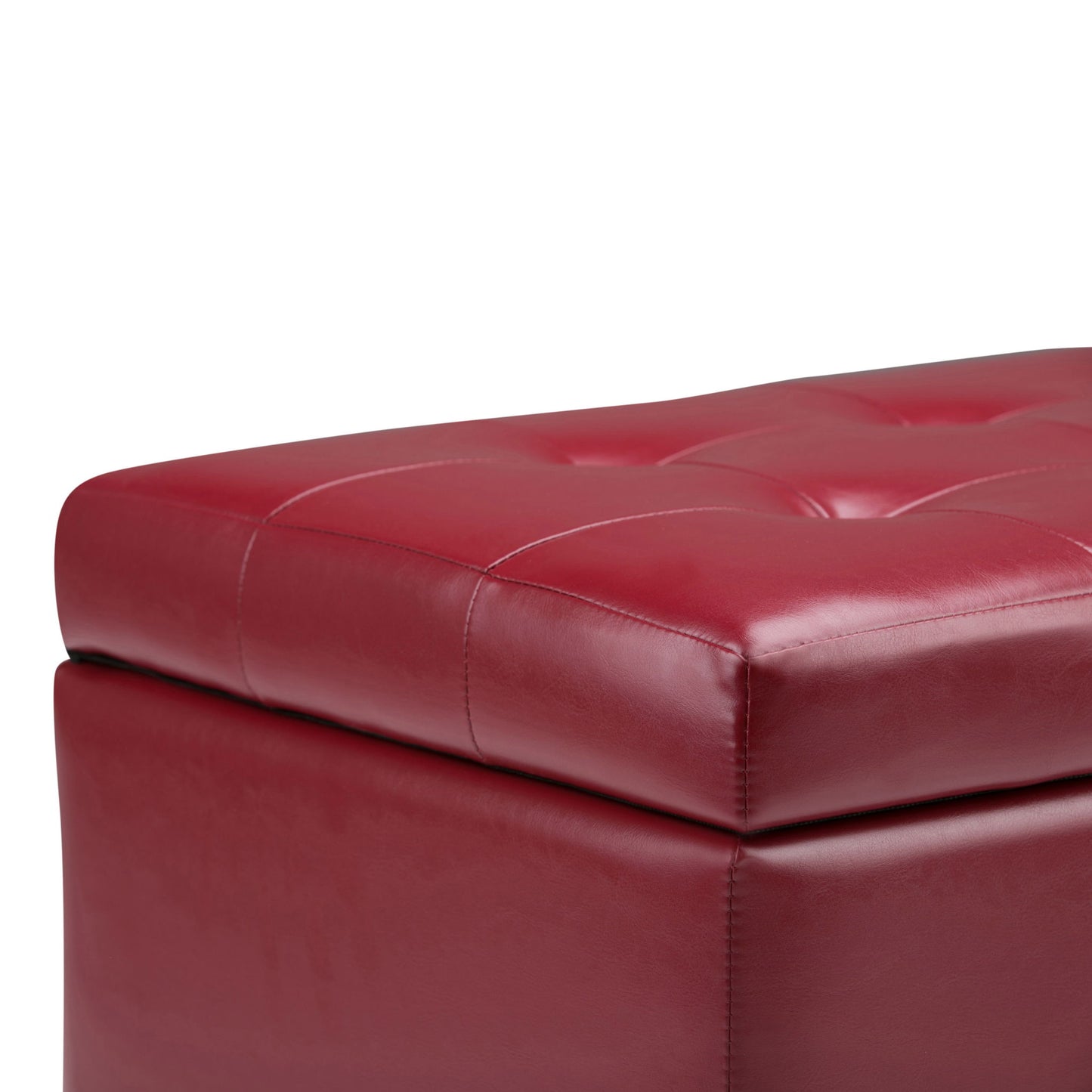 Close-up of the Cosmopolitan Upholstered Storage Ottoman featuring red leather with tufted stitching on the cushioned top.
