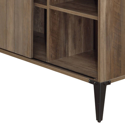 A close-up of the Zakwani Writing Desk highlights its open shelves, dark metal legs, visible wood grain texture, and sturdy construction.