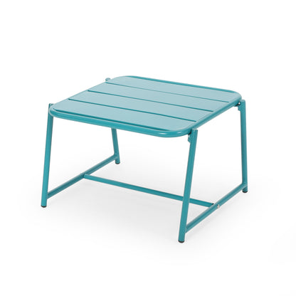 The Conrad - Side Table Outdoor features a turquoise metal design with a slatted square top, four angled legs, and a connecting horizontal support bar, all set against a plain white background.