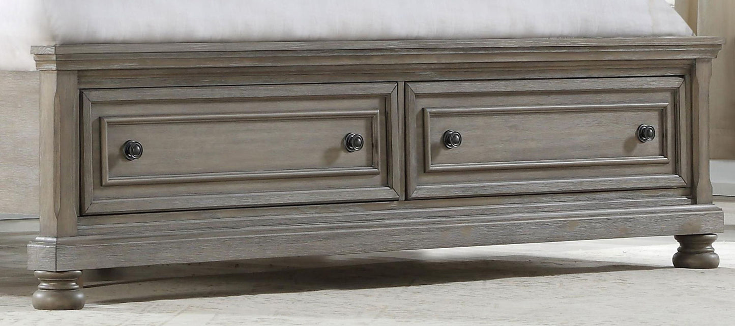 The Elegant Design Storage Bed features two front drawers, paneled detailing, round metal knobs, and turned legs, shown placed at the foot of a bed on a light-colored carpet.