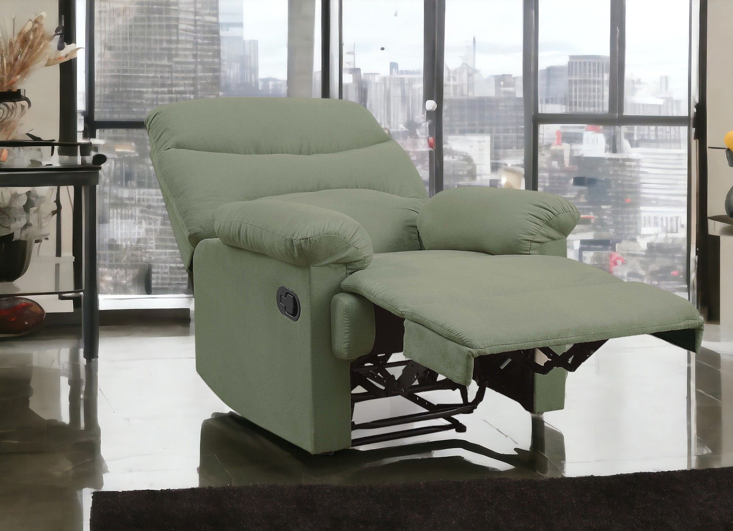 The Arcadia Micro Motion Glider Recliner in light green, featuring an extended footrest, is placed in a modern living room with large windows that reveal a stunning city skyline.