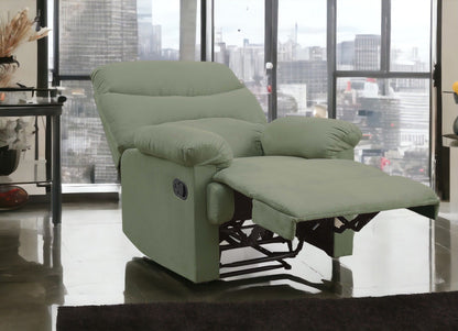 The Arcadia Micro Motion Glider Recliner in light green, featuring an extended footrest, is placed in a modern living room with large windows that reveal a stunning city skyline.