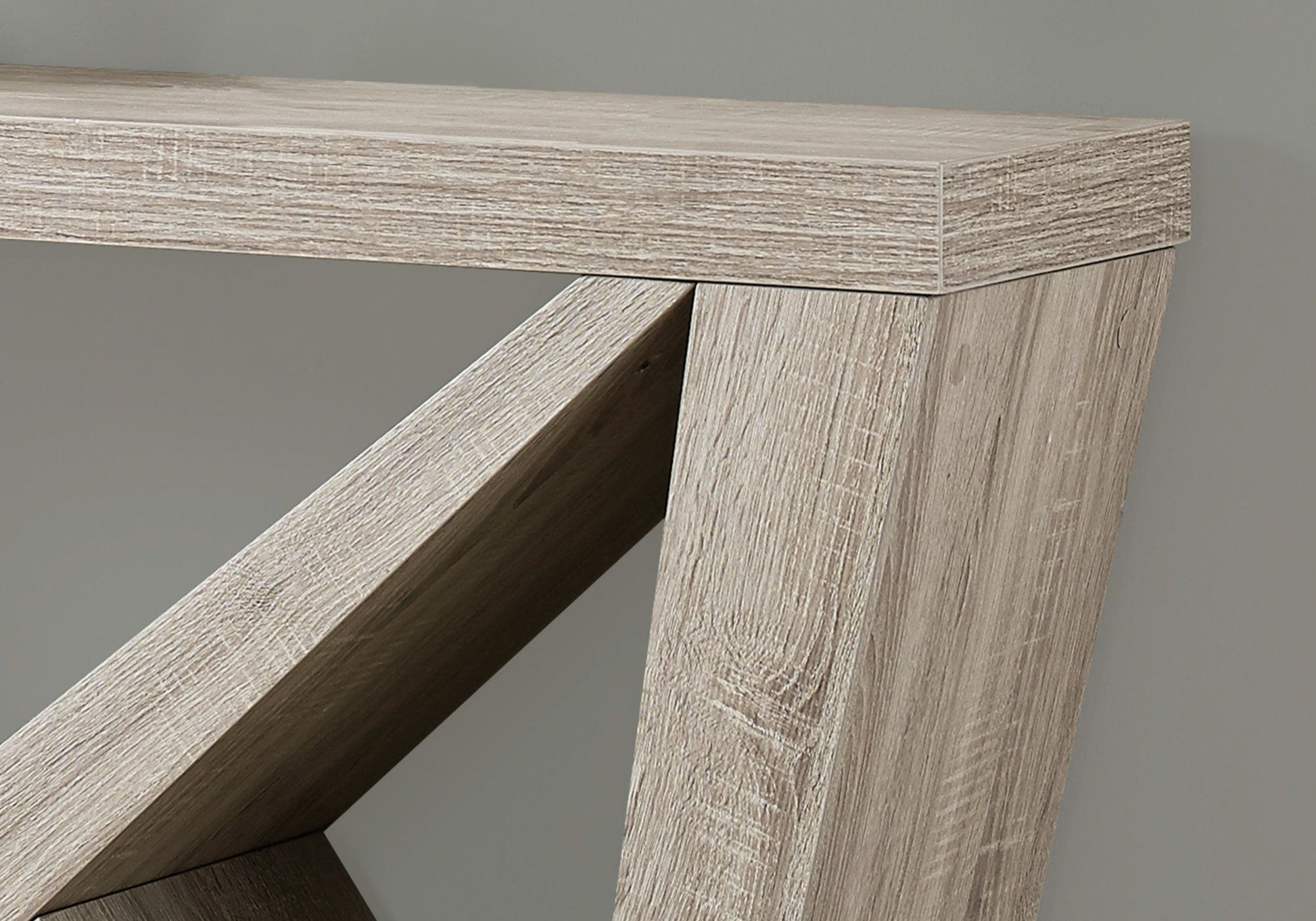 A close-up of the Accent Console Table For Entryway shows its light-colored wood, modern angled legs, and durable construction, set against a plain gray background.