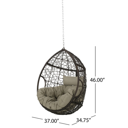 The Teardrop - Hanging Chair With 8Ft Chain features an egg-shaped brown woven frame, khaki seat cushion, headrest, and is suspended by a chain. Dimensions are 46"H x 37"W x 34.75"D.