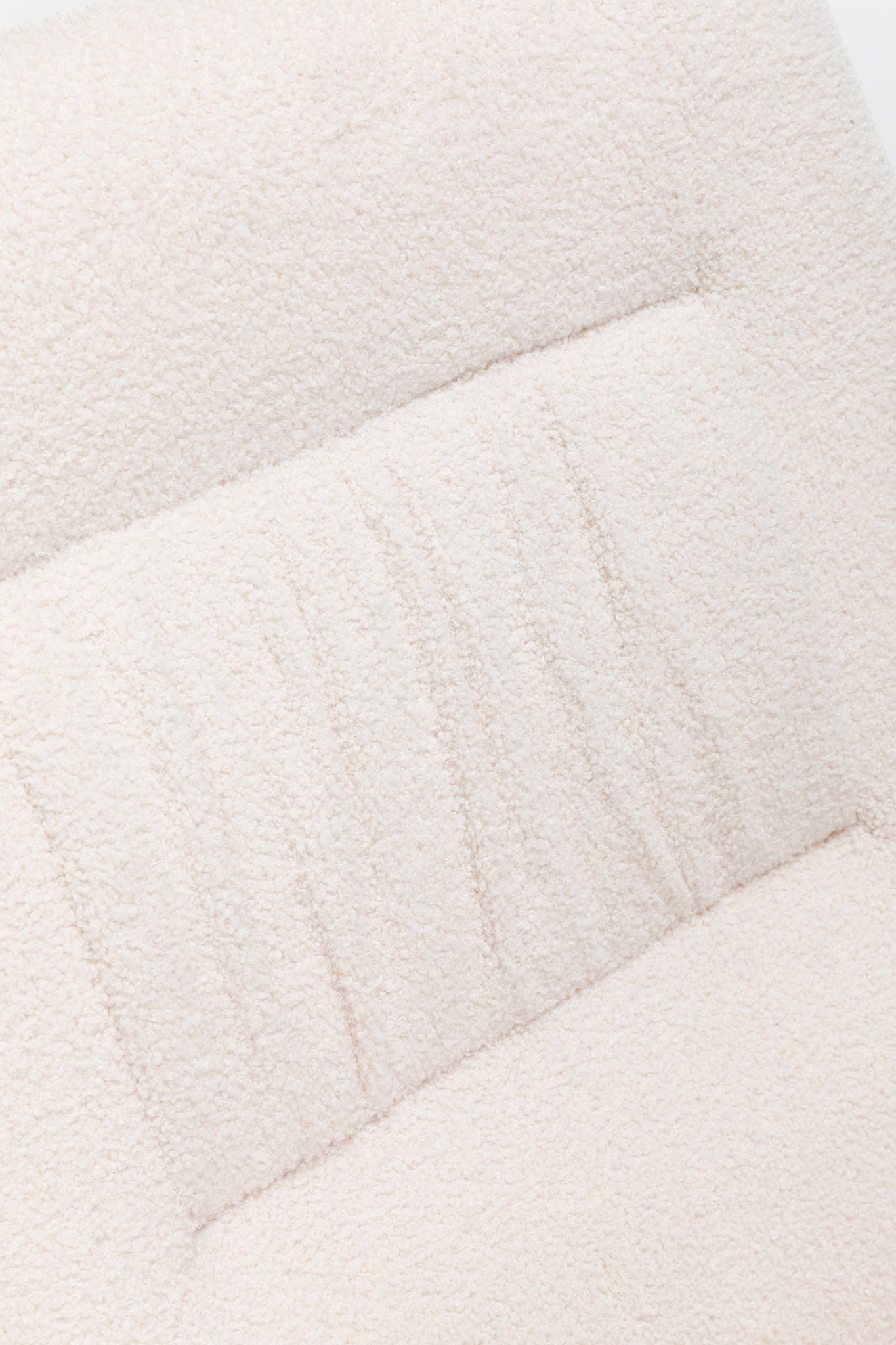 Close-up of the textured cream fabric upholstery with subtle horizontal lines and stitched sections on the Rocking Chair Nursery, Teddy Upholstered Glider Rocker with High Backrest, perfect for modern living rooms.