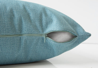 A close-up of the Pillow Square decorative throw cushion, showing its blue textured cover with a partially open zipper that reveals the hypoallergenic insert included.