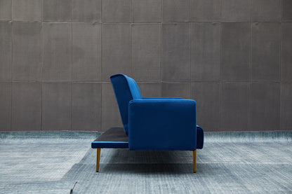 The Comfort Compact Design Sofa Bed in modern blue with gold legs is shown side-on before a gray tiled wall, set on a blue-toned textured floor.