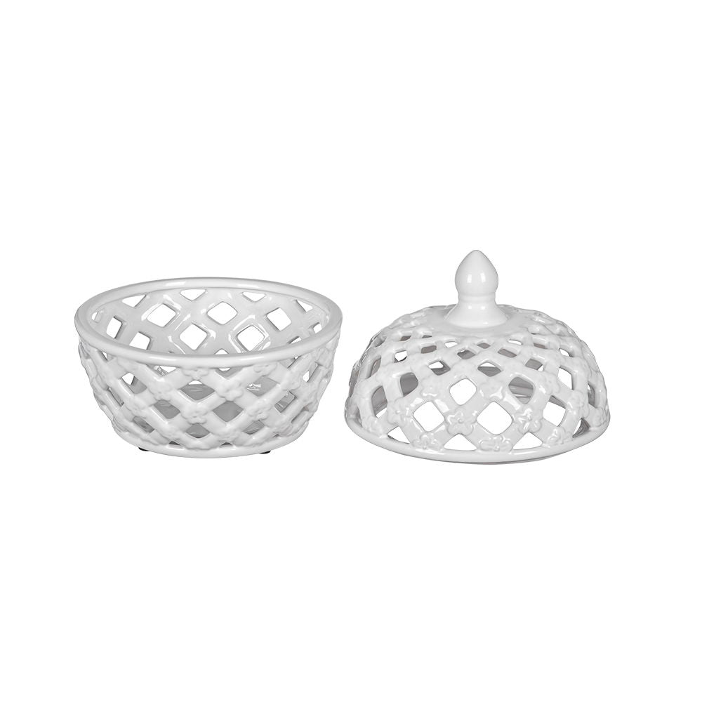 The Ceramic Lidded Jar With Lattice Design - White features a ceramic basket with diamond-shaped cutouts and a matching handled lid, both styled in a white lattice pattern. The lid is shown positioned beside the jar.