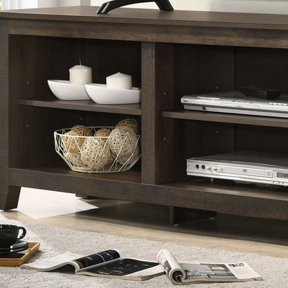 The Benito - TV Stand With Open Shelves And Cable Management displays white bowls, pillar candles, a wire basket with wicker balls, and electronics. A magazine and black cup sit on the rug in front.