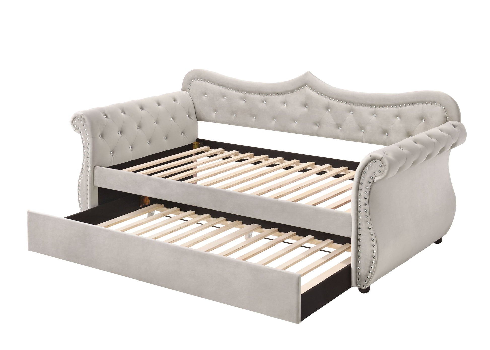 The Adkins Twin Daybed With Trundle in beige features light gray upholstery, a tufted back and arms, decorative trim, wooden slats, and an extended pull-out trundle bed underneath.