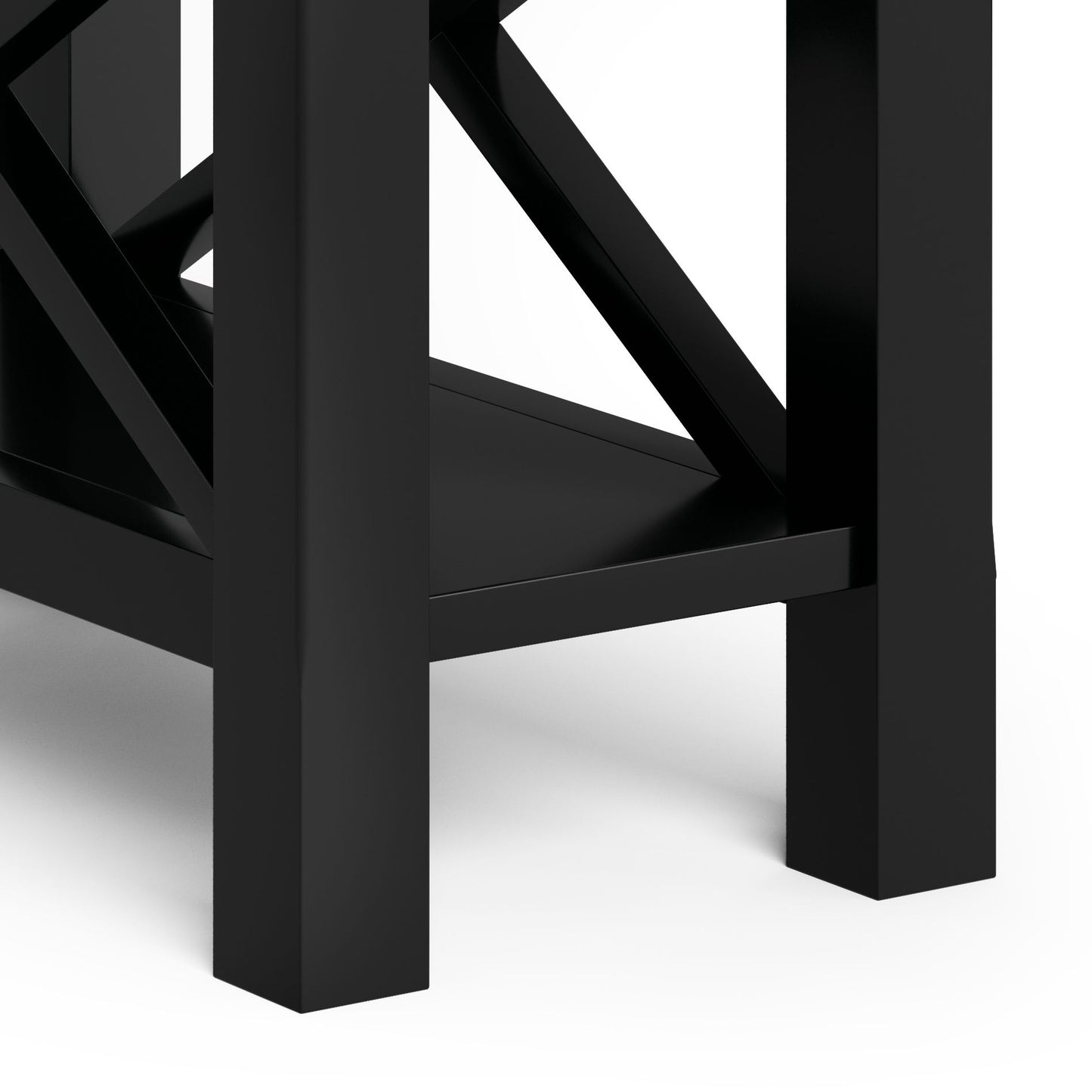 Close-up of the lower part of the Kitchener - Handcrafted Table, featuring four sturdy black legs, a shelf, and cross-bracing against a white background.