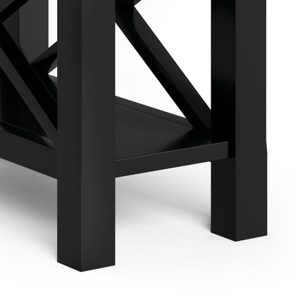 Close-up of the lower part of the Kitchener - Handcrafted Table, featuring four sturdy black legs, a shelf, and cross-bracing against a white background.