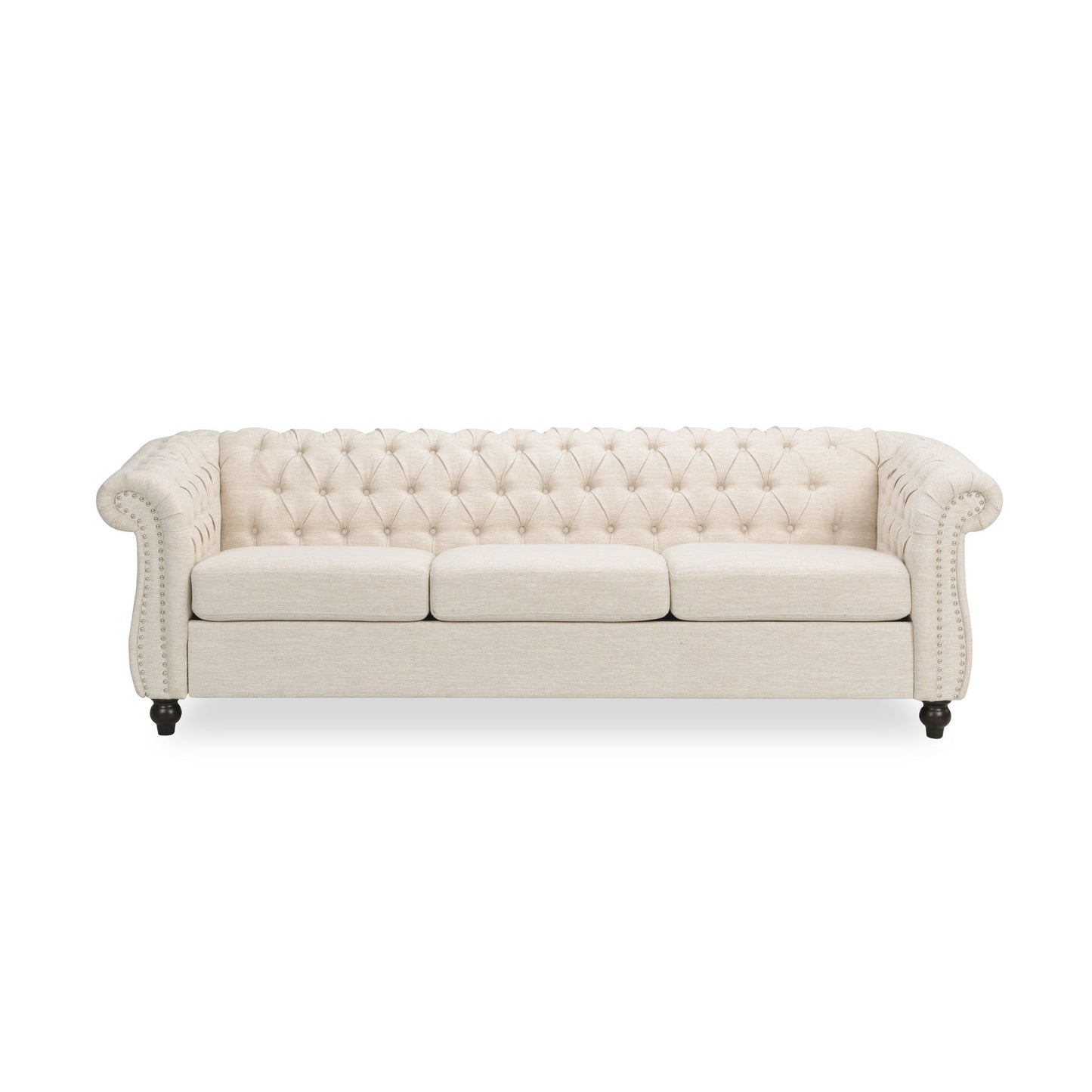 The Chesterfield Style 3 Seater Sofa features cream upholstery, deep button tufting, rolled arms, nailhead trim, and three seat cushions. Shown with short dark wooden legs against a white background.