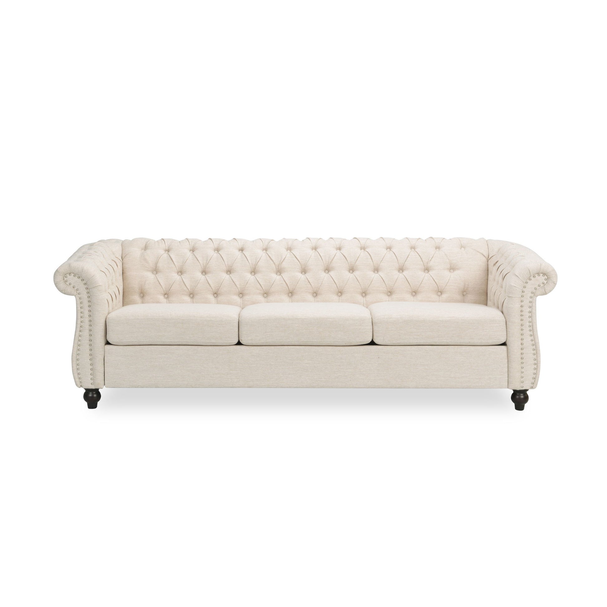 The Chesterfield Style 3 Seater Sofa features cream upholstery, deep button tufting, rolled arms, nailhead trim, and three seat cushions. Shown with short dark wooden legs against a white background.