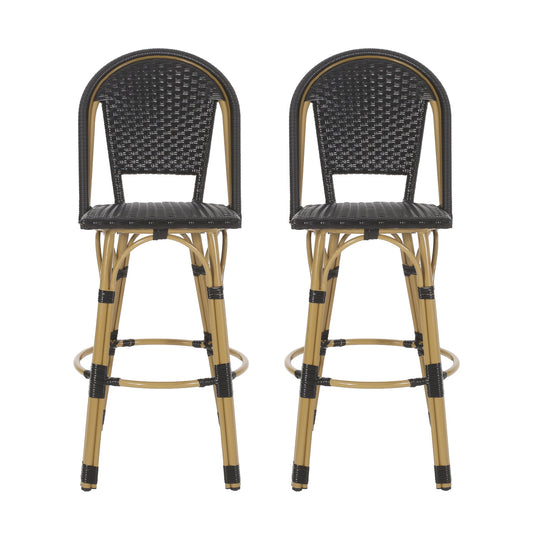 A set of two Outdoor Rattan And Aluminum French Barstools with woven black seats, tan bamboo-style legs, and round footrests are placed side by side against a white background.