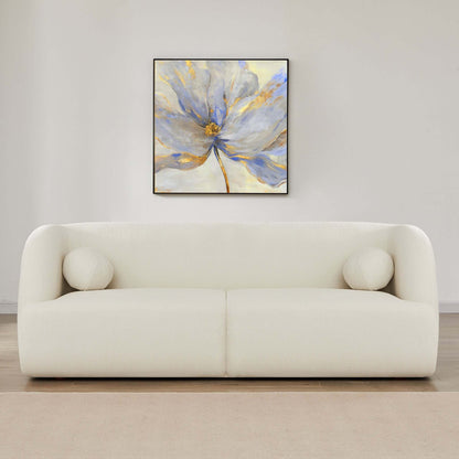 A minimalist living room features the Anna - French Boucle Sofa, topped with two round white cushions, a beige rug underfoot, and a large abstract blue, white, and gold flower painting hanging on the wall above the sofa.