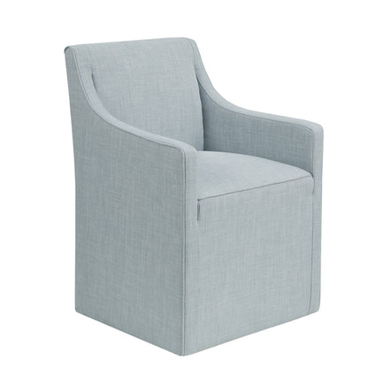 The Traditional Skirted Dining Arm Chair is upholstered in light blue fabric, featuring a boxy, straight-edged design and a skirted base, shown against a white background.