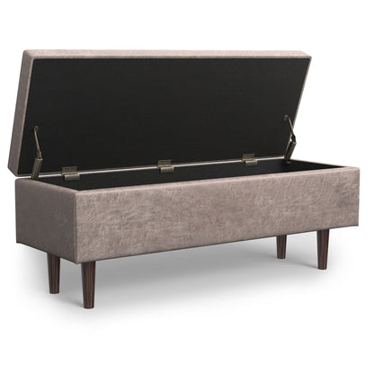 The Shay Large Square Coffee Table Storage Ottoman, in mid-century style, features light brown upholstery, four wooden legs, and an open hinged lid that reveals a spacious storage compartment inside.