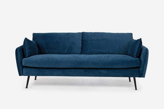 The Park Sofa is a modern blue velvet piece featuring two seat cushions, two back cushions, and slim black metal legs, shown against a plain white background.