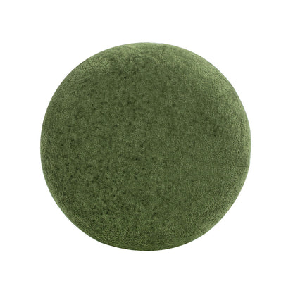 The Nest - Low Round Upholstered Ottoman is a green, textured cushion shown from above against a white background.