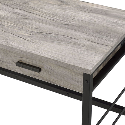 A close-up of the Disho - Weathered Writing Desk With USB in oak, highlighting its light gray wood surface, black metal frame with lower crossbar, and sleek metal drawer handle.