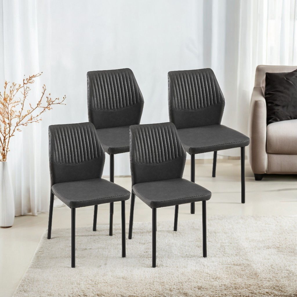 Four modern black Dining Chairs Living Room Chair Modern Kitchen Armless Side Chair With Metal Legs are arranged on a light rug in a bright room, with a beige sofa, sheer curtains, and a dried plant in the background.