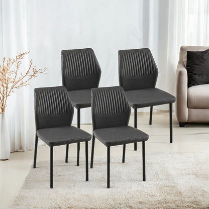 Four modern black Dining Chairs Living Room Chair Modern Kitchen Armless Side Chair With Metal Legs are arranged on a light rug in a bright room, with a beige sofa, sheer curtains, and a dried plant in the background.
