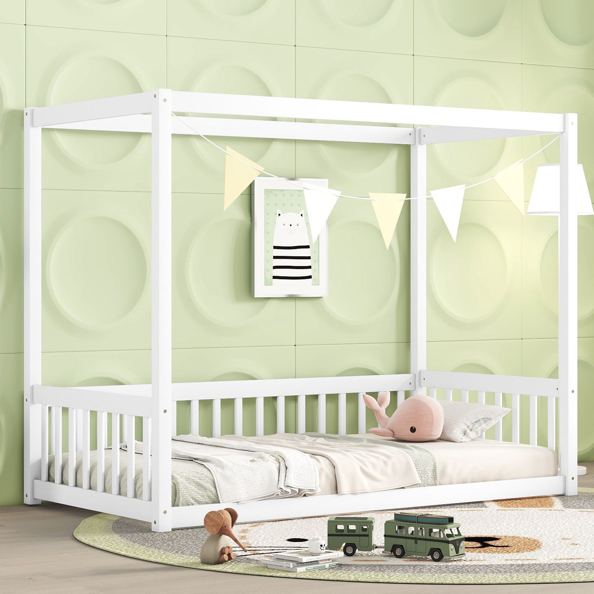 A children’s room featuring the Canopy Frame Floor Bed With Fence, Guardrails, pastel green 3D wall panels, a framed animal print, white bunting, a plush whale pillow, bed linens, and toy vehicles on a round rug.