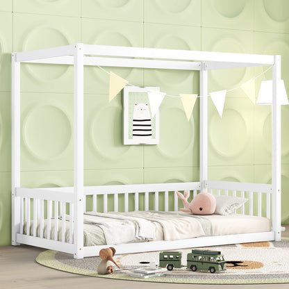 A children’s room featuring the Canopy Frame Floor Bed With Fence, Guardrails, pastel green 3D wall panels, a framed animal print, white bunting, a plush whale pillow, bed linens, and toy vehicles on a round rug.