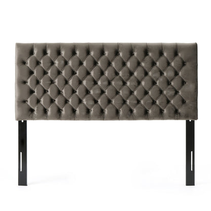 The Annecy - Contemporary Upholstered Headboard features a rectangular, tufted gray design with a diamond pattern and two black metal support legs, displayed against a white background.