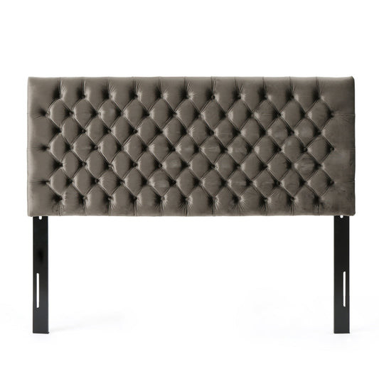 The Annecy - Contemporary Upholstered Headboard features a rectangular, tufted gray design with a diamond pattern and two black metal support legs, displayed against a white background.