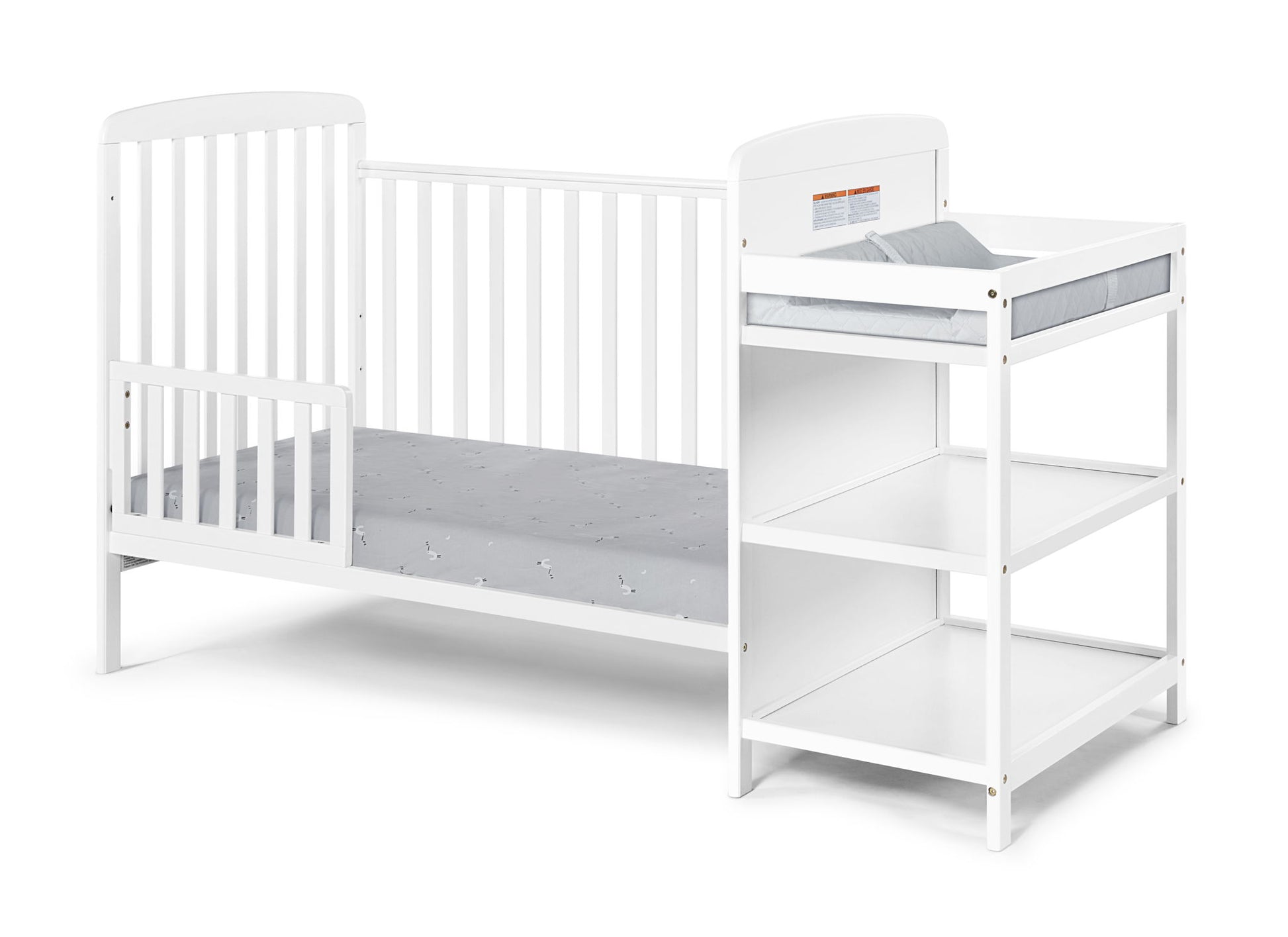 The Ramsey 3-in-1 Convertible Crib / Changer Combo is a white wooden baby crib with an attached changing table, two storage shelves, and a padded changing mat, shown against a plain white background.