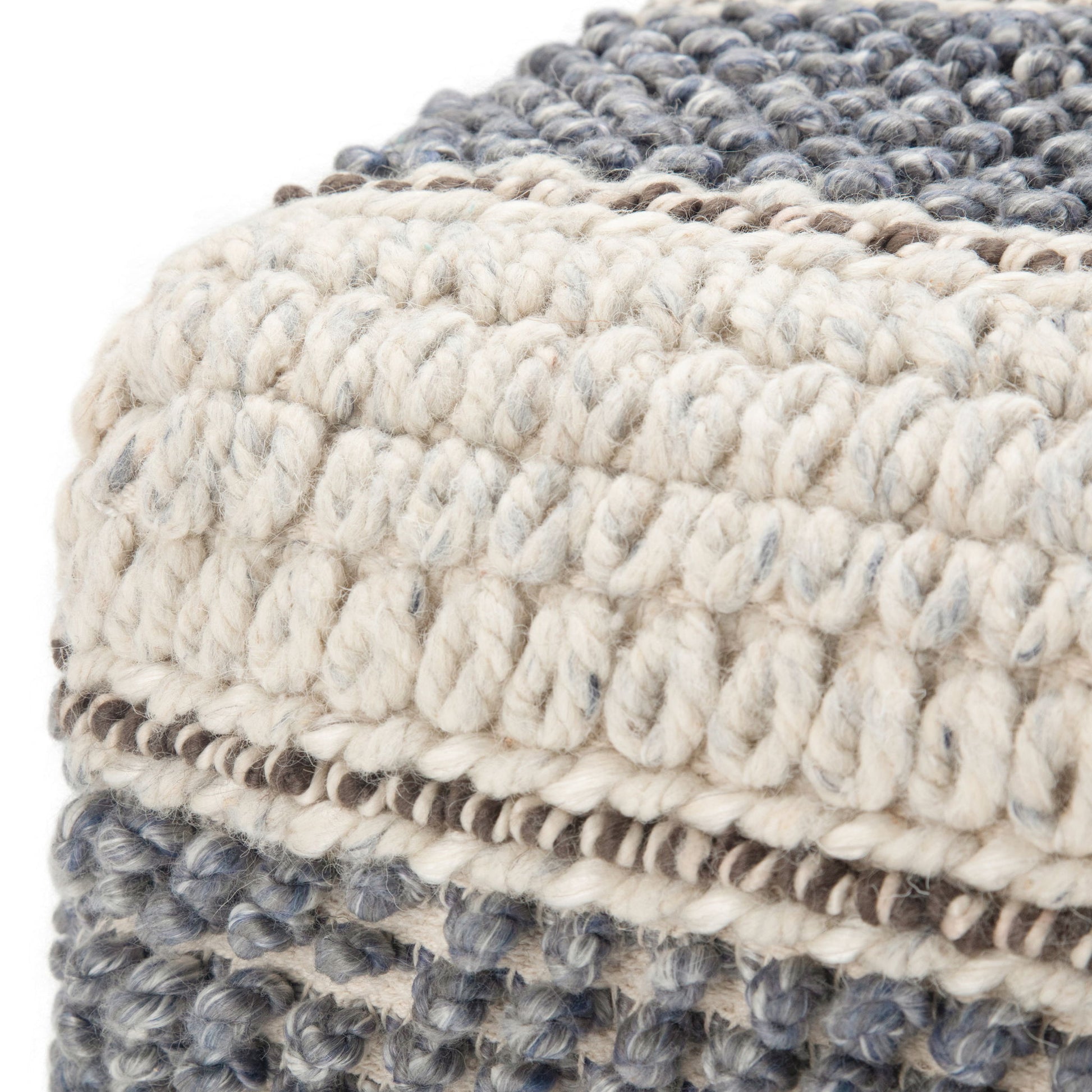 Close-up of the Grady Handcrafted Square Pouf, featuring thick cream and gray yarn in various woven patterns for a textured, soft square cushion.