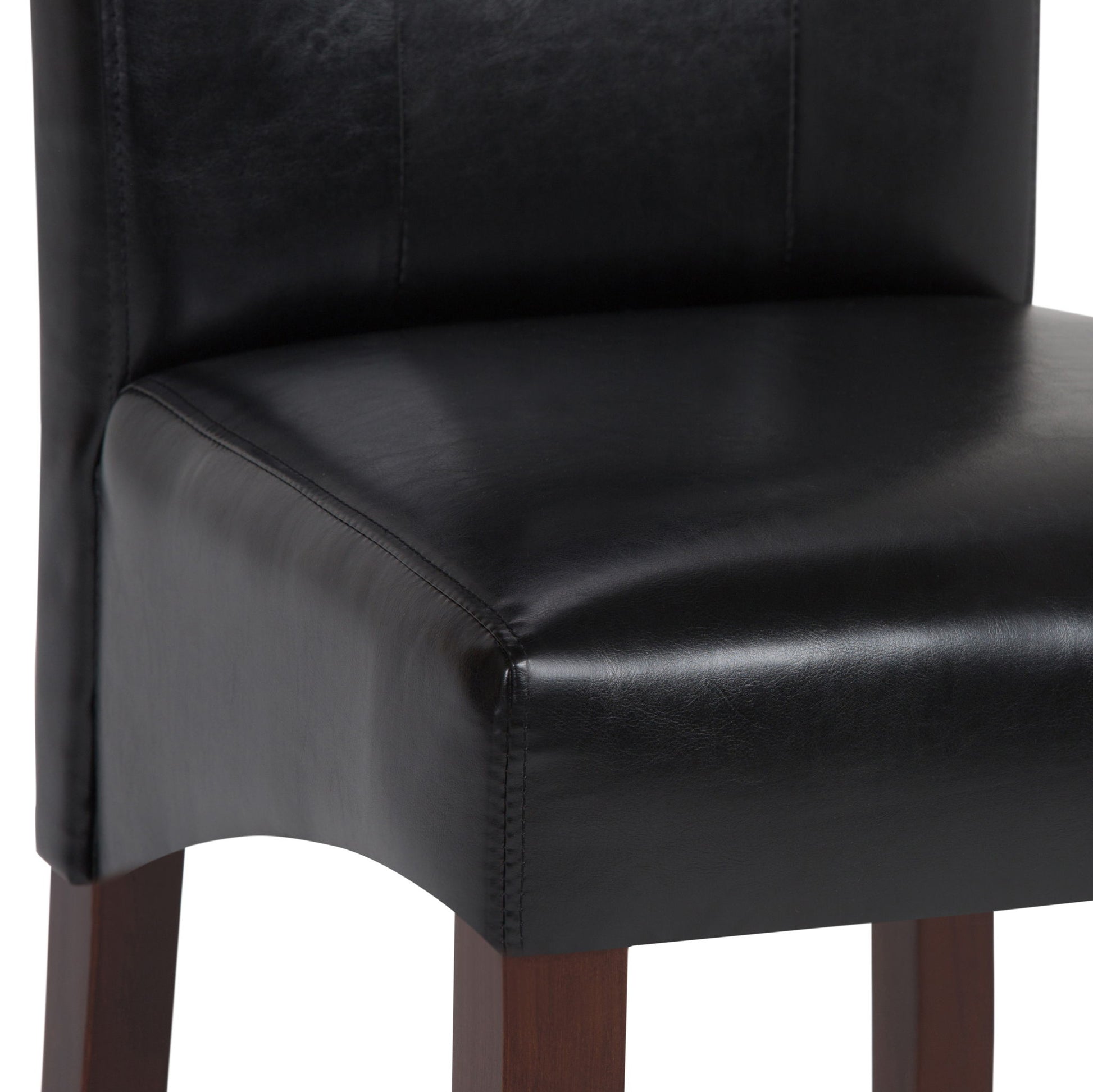Close-up of the Cosmopolitan - Deluxe Tufted Parson Upholstered Chair, showcasing its black leather seat and backrest with dark wooden legs. The visible stitching and smooth leather texture highlight its elegant design. Comes as a set of 2.