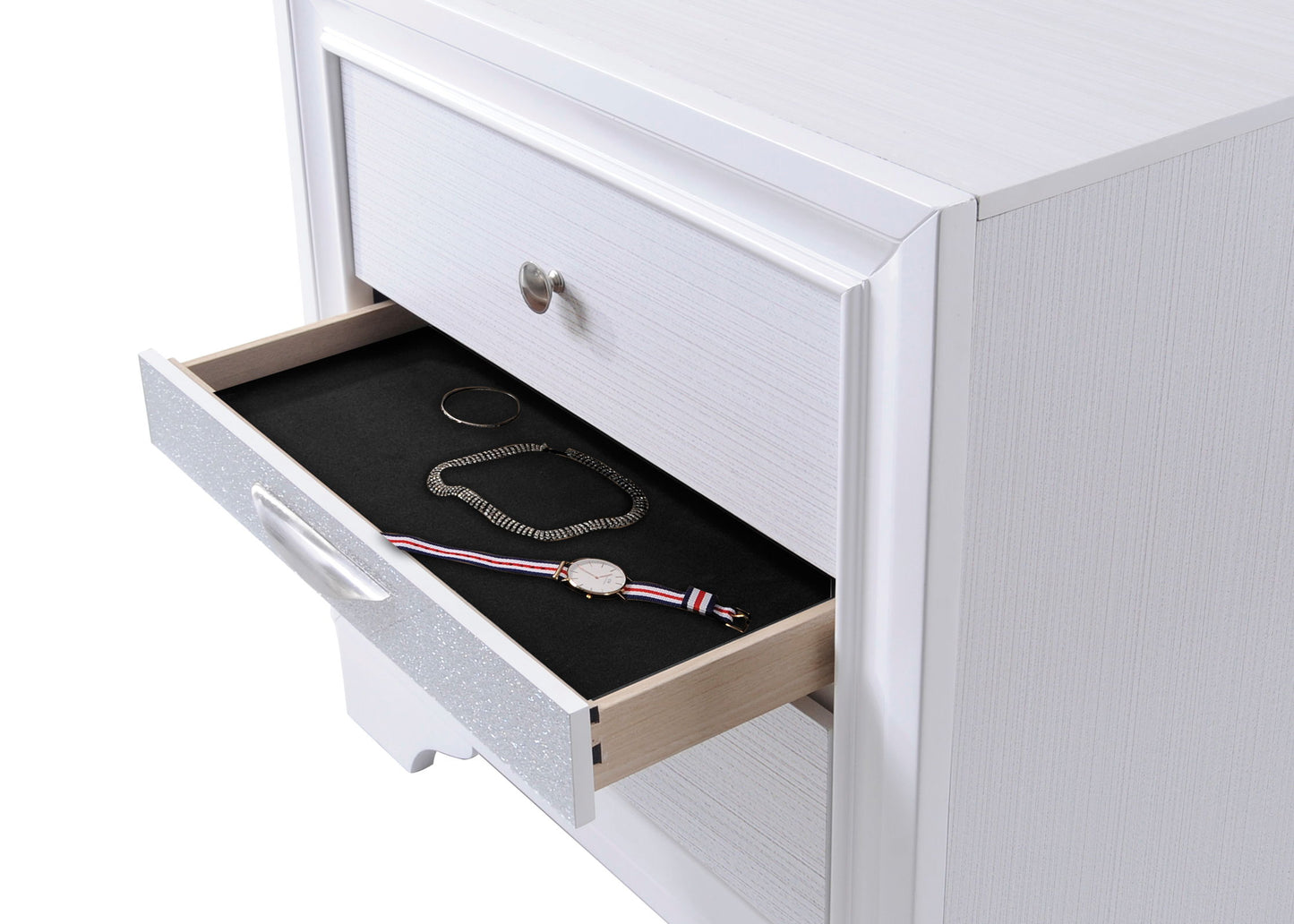 A close-up of the Naima - Chic Design Nightstand with an open drawer, revealing a gold bracelet, silver chain, and striped band wristwatch resting on black felt lining.